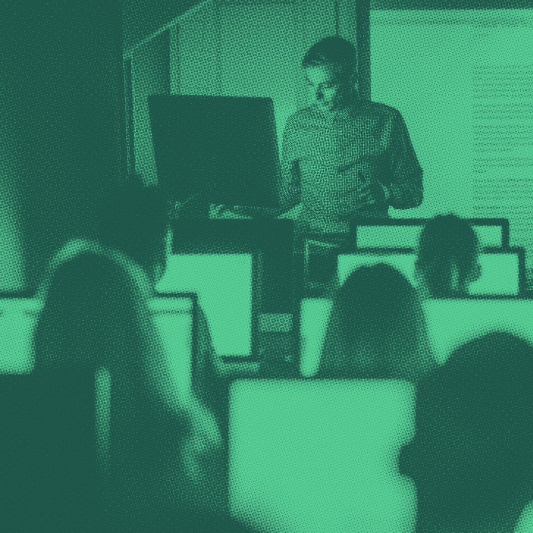 Teacher teaching a coding education class in a computer lab