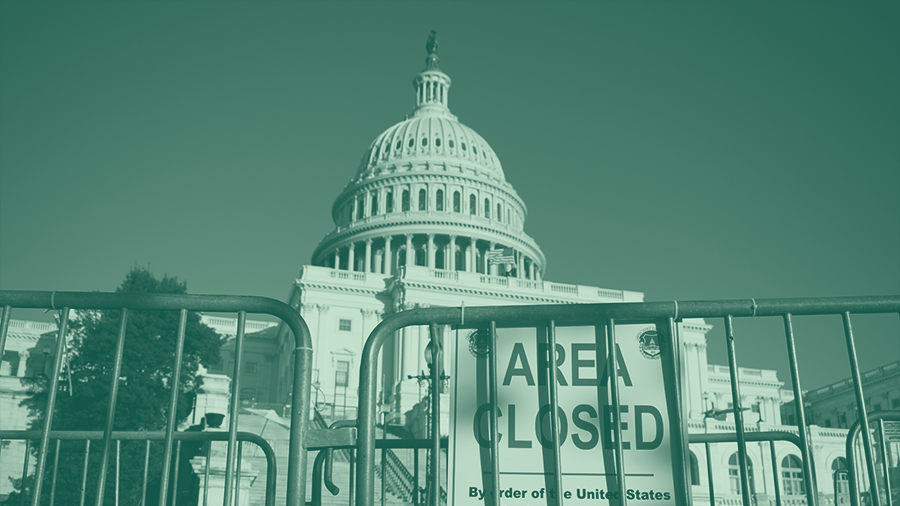 United States Capitol building with barricades and sign that says 