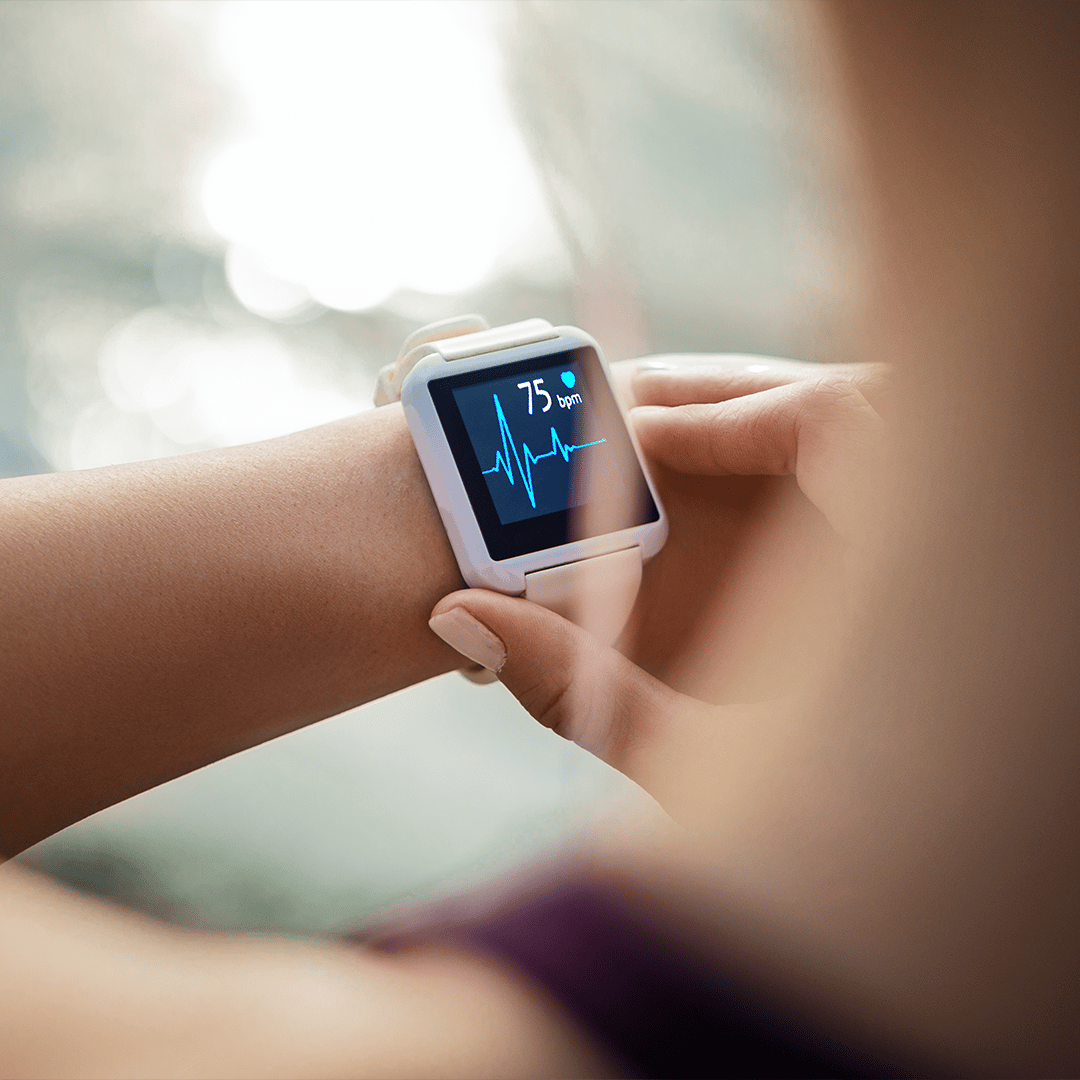 Person checking health data/biometrics on a smart watch